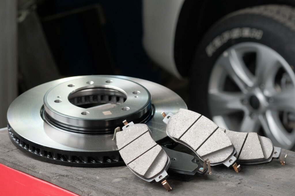 A brake disc rotor and pads resting on a bench answering if brake checking is illegal in Florida with laws and penalties.