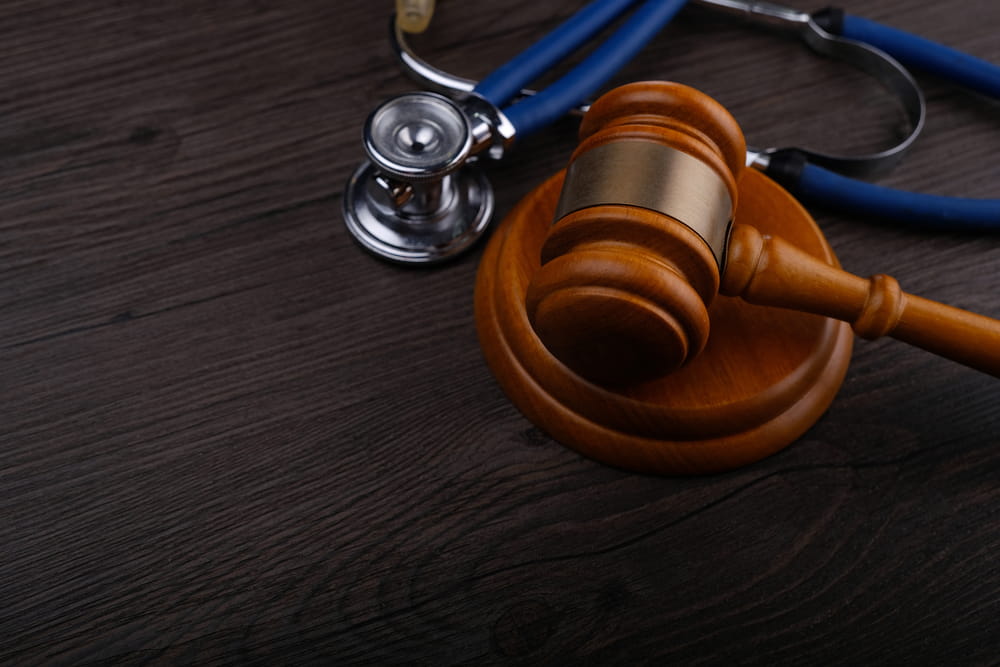 Judge&rsquo;s gavel beside a stethoscope on a desk, representing bodily injury claims, medical evidence, and Florida personal injury law.