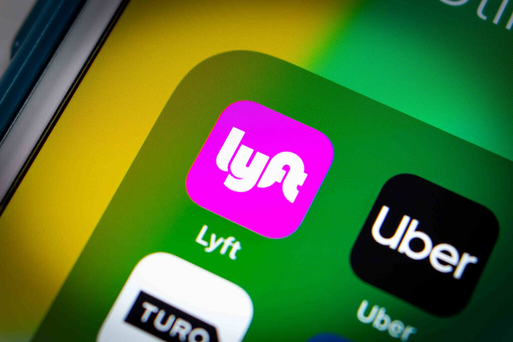 A smartphone screen displaying Uber and Lyft app logos for cases handled by a Pembroke Pines Uber and Lyft Accident Lawyer.