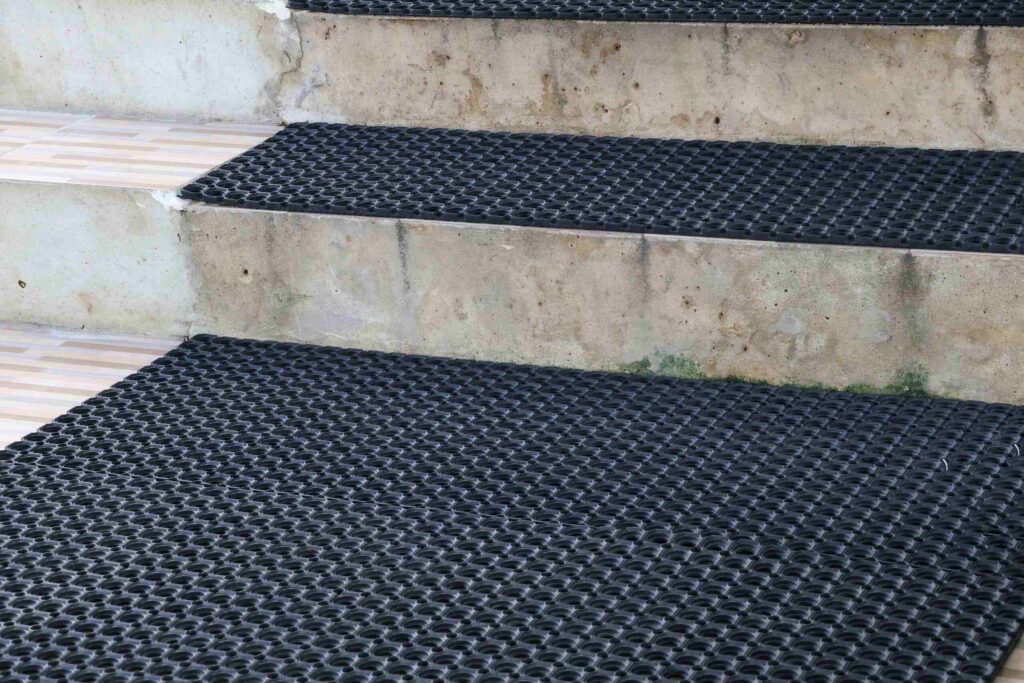 Outdoor stairs equipped with non-slip rubber mats demonstrating how premises liability works in Pembroke Pines stores, restaurants, and hotels.