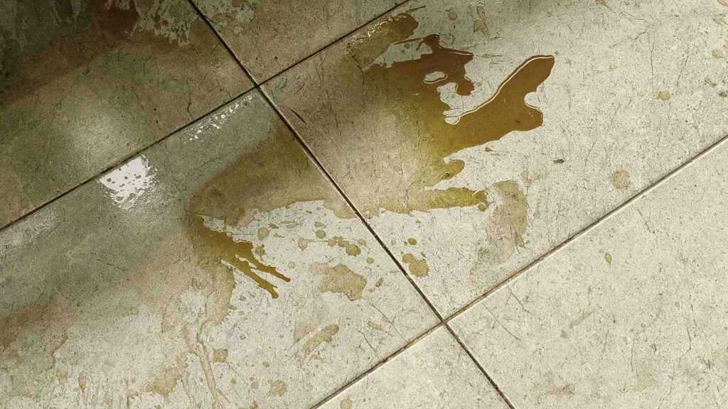 A dirty liquid spill on a tiled floor illustrating how premises liability works in Pembroke Pines stores, restaurants, and hotels.